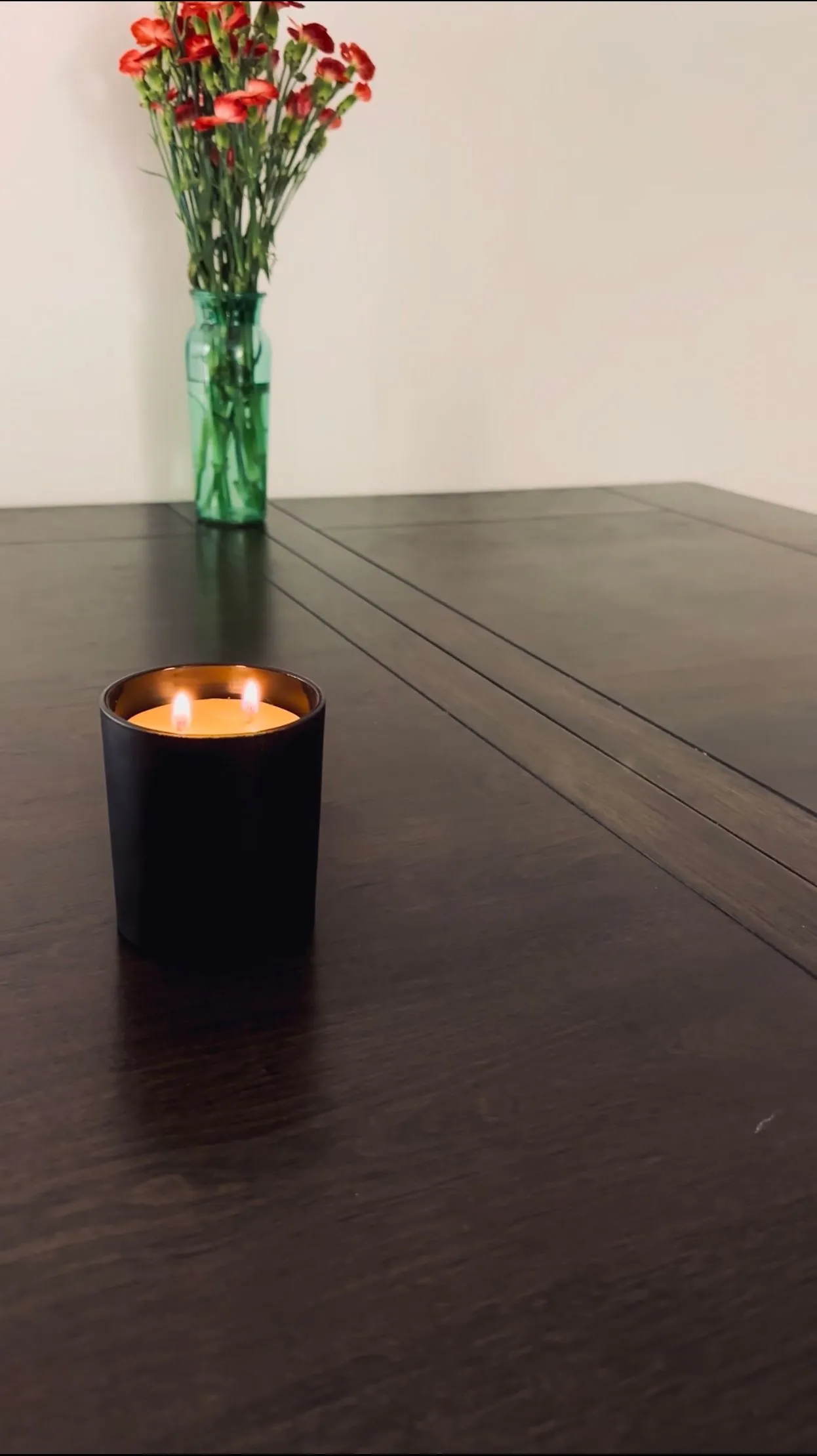 Unscented beeswax candle in a matte black glass jar